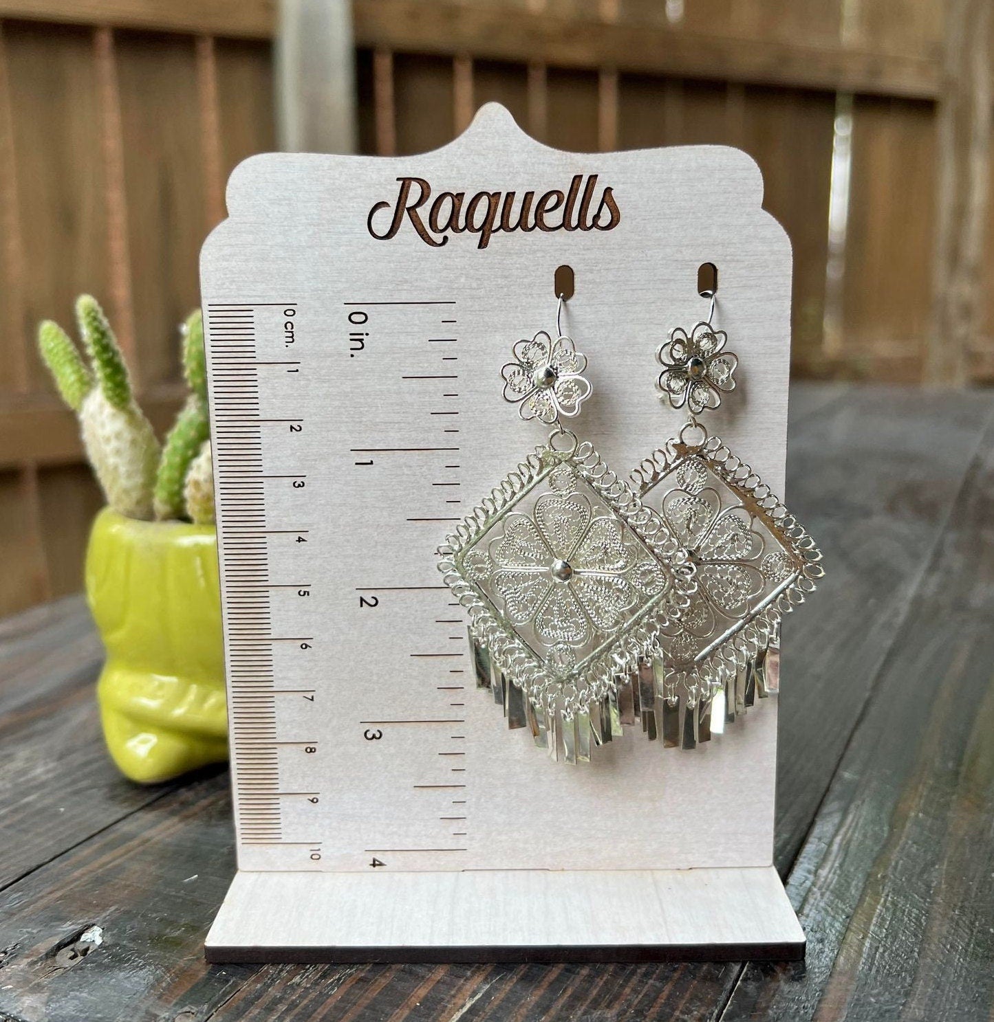 Image of Silver Filigree Earrings on length measure. The drop length is three inches.