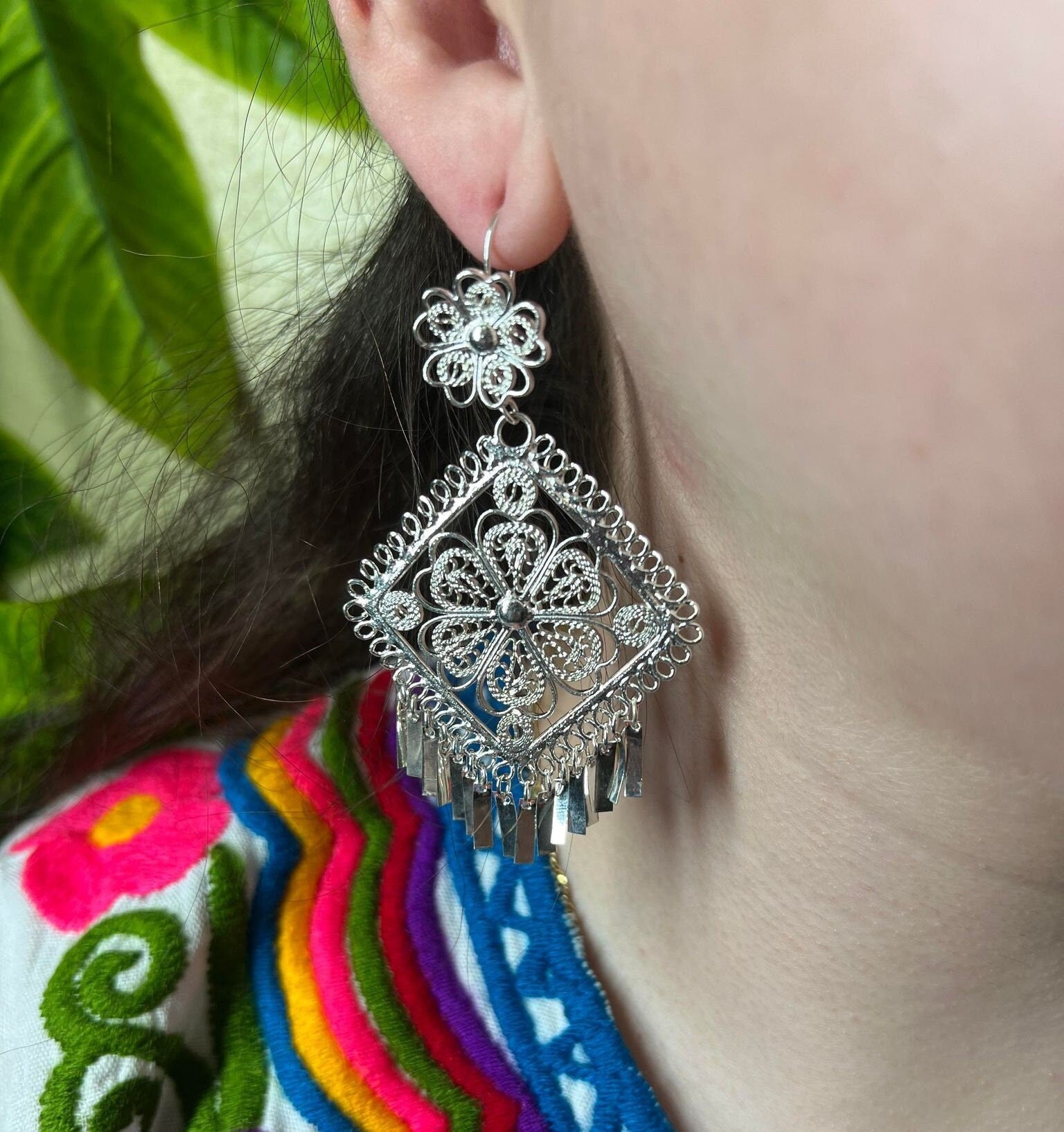 Image of Silver Filigree Earrings on earlobe. The drop length is three inches.
