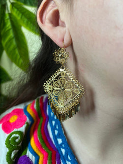 Image of Gold Filigree Earrings on earlobe. The drop length is three inches.